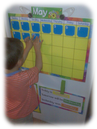 Child putting numbers on calendar